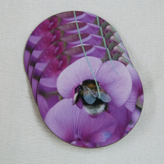 Four garden bumblebee round coasters, pink sweetpea flower, spread view