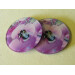 Two garden bumblebee round glass coasters, pink sweet pea flower, tilt view